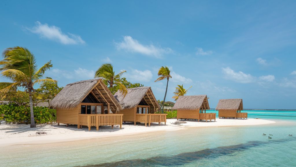 sunny day in aruba with a view of the beach and huts